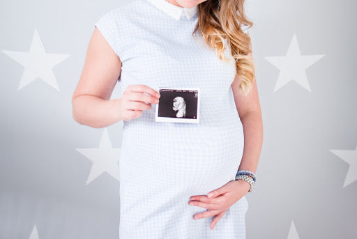 Pregnant woman holding an ultrasound scan 