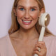 Zobelle Sonica Silicone Body Brush being held near the face of a female