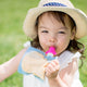 Lifestyle shot of a toddler enjoying her food or drink from the On the go food pouch