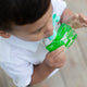 Lifestyle image of a toddler holding his green On the go Maxi pouch and enjoying his drink or meal.